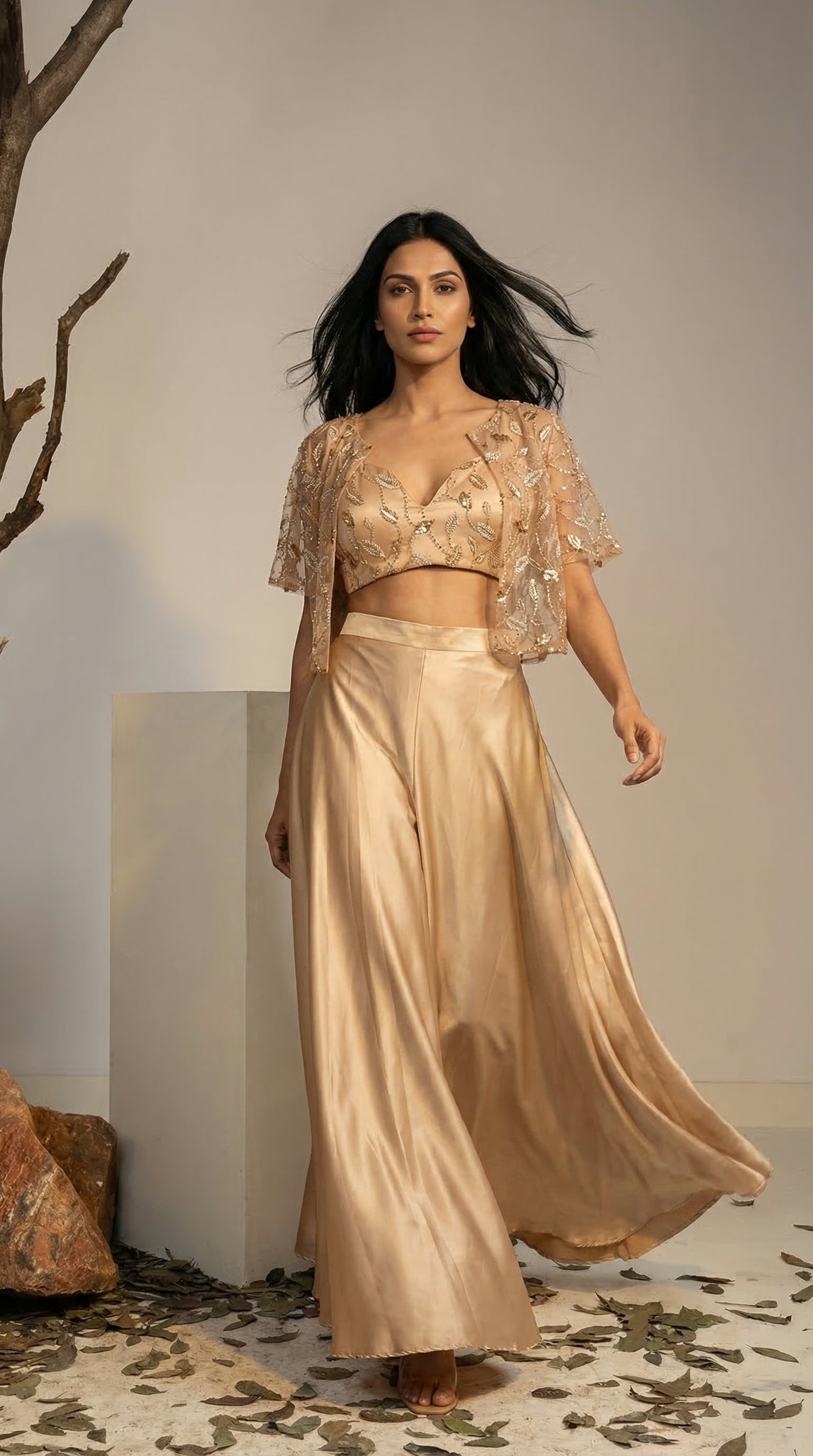 Woman in champagne embroidered cape set with flowy palazzo, ideal for Navratri and Garba nights
