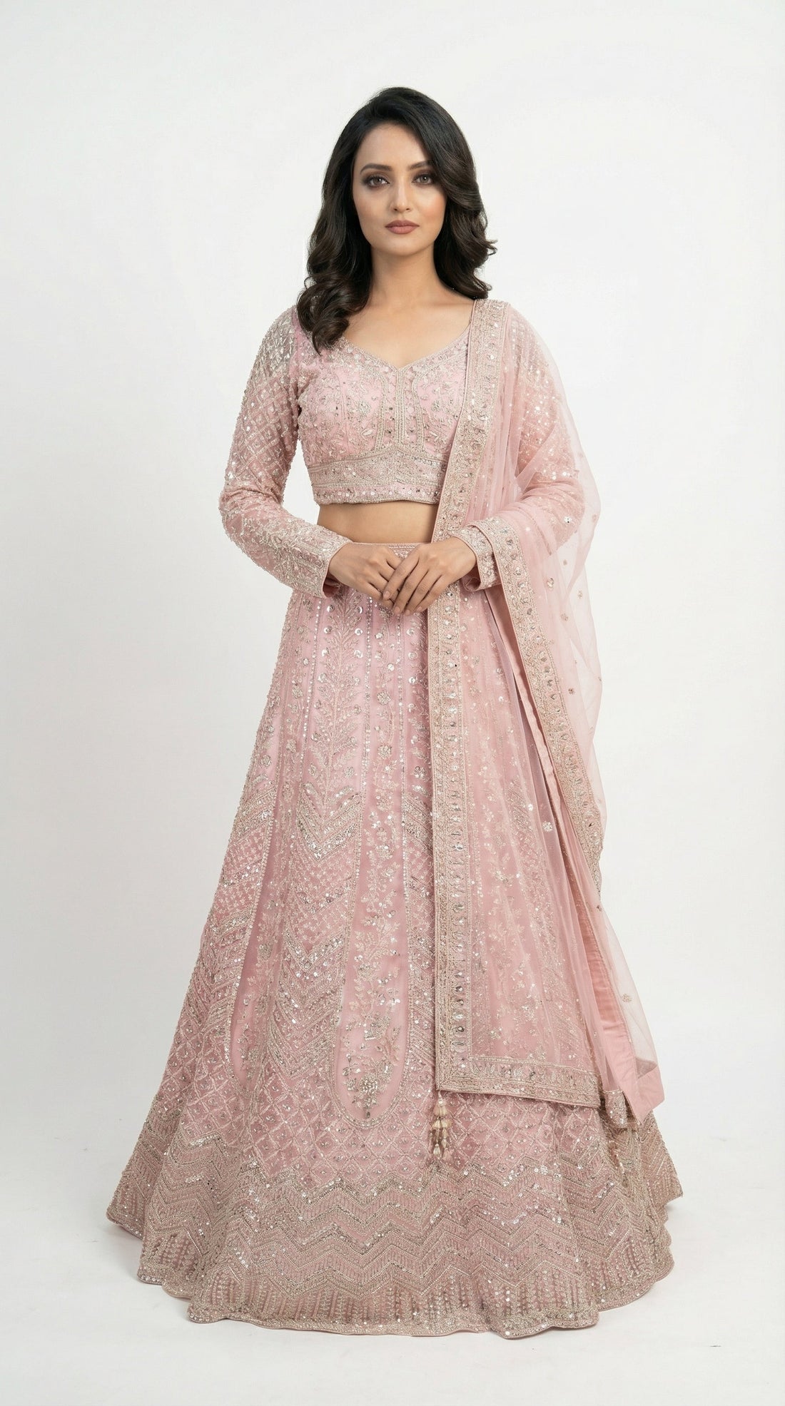 Woman wearing a pink traditional outfit with a white background — featured in Rosio House blog post: Engagement Lehenga Ideas: How to Choose Your Perfect Look