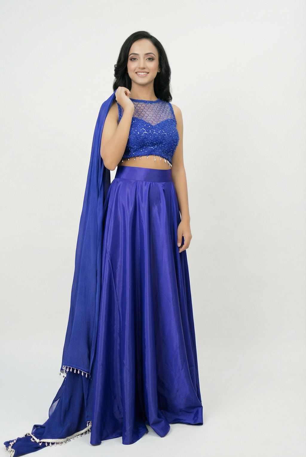 The voluminous royal blue satin skirt of the lehenga set showing its flared silhouette and smooth, lustrous fabric texture.