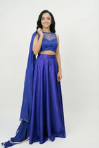 The voluminous royal blue satin skirt of the lehenga set showing its flared silhouette and smooth, lustrous fabric texture.