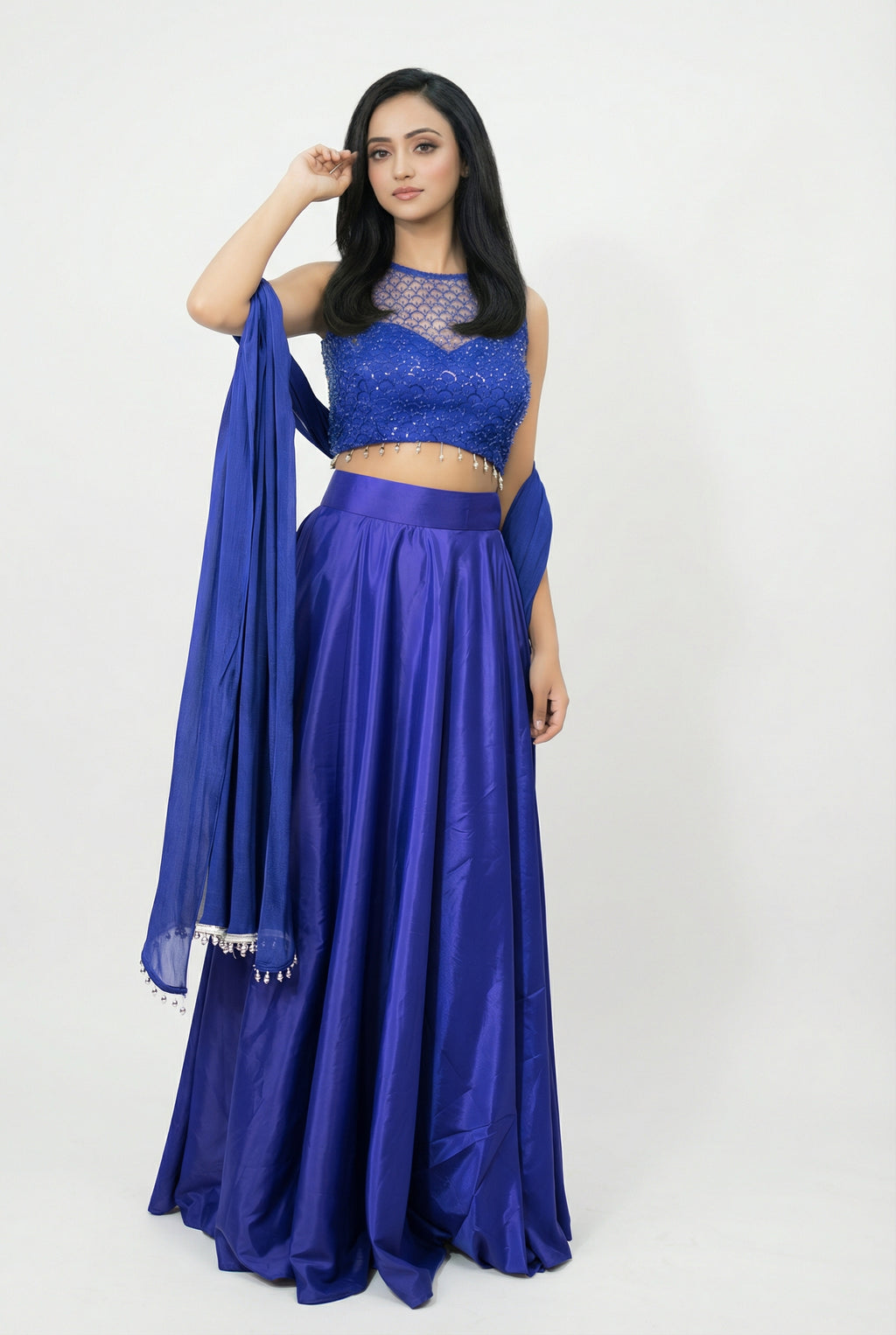 Detail shot of the matching blue dupatta featuring delicate silver bead tassels on the borders.
