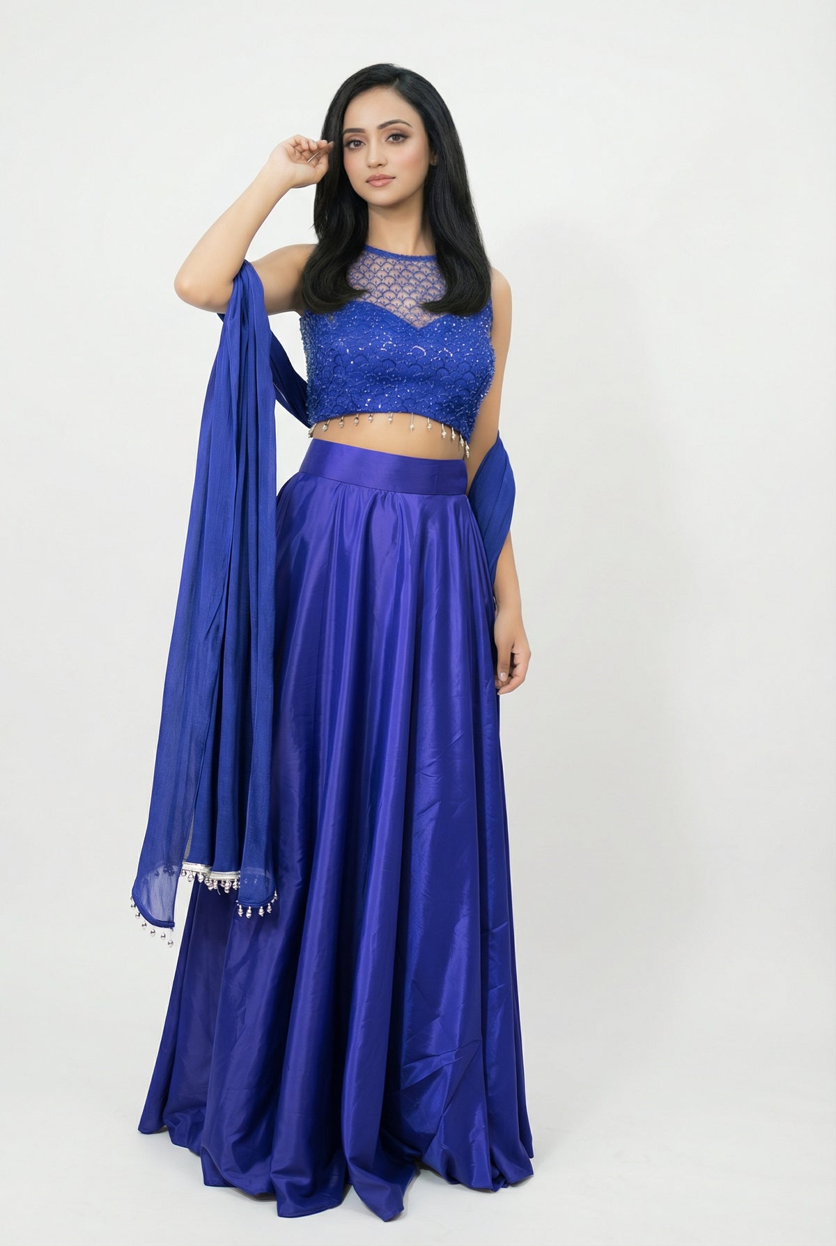 Detail shot of the matching blue dupatta featuring delicate silver bead tassels on the borders.