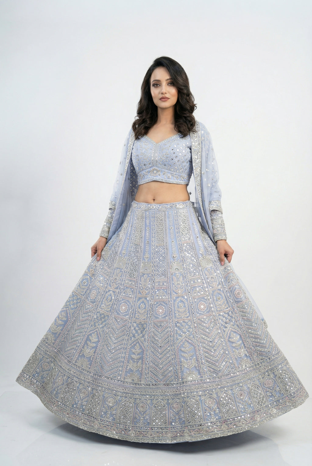 The sheer lavender net dupatta draped over the lehenga, highlighting the heavy embroidered border and scattered sequin motifs.