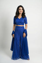 Detail shot of the wide-leg royal blue sharara pants showing the flared silhouette and sparkly texture.