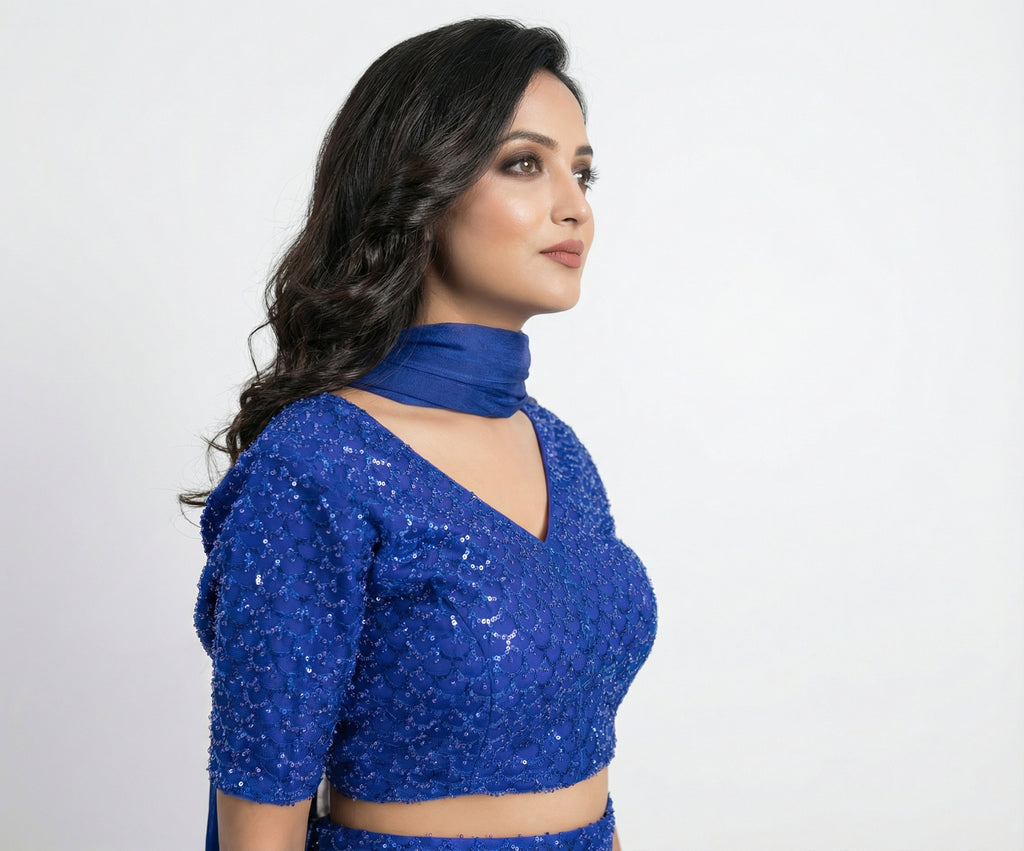 The long, sheer blue dupatta draped elegantly, featuring delicate hanging beads/tassels on the border.