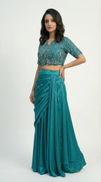 Close-up detail of the intricate vertical silver cutdana bead embroidery on the firozi crop top, showing the V-neck and short sleeves.