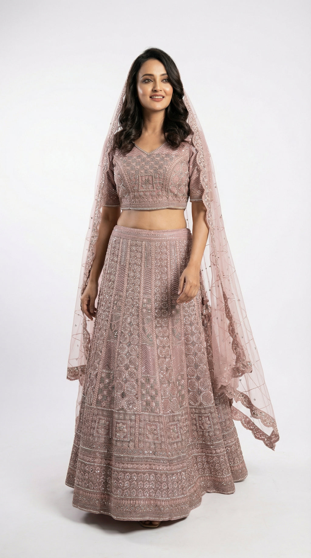 Woman wearing a traditional outfit with a patterned dress and dupatta on a white background