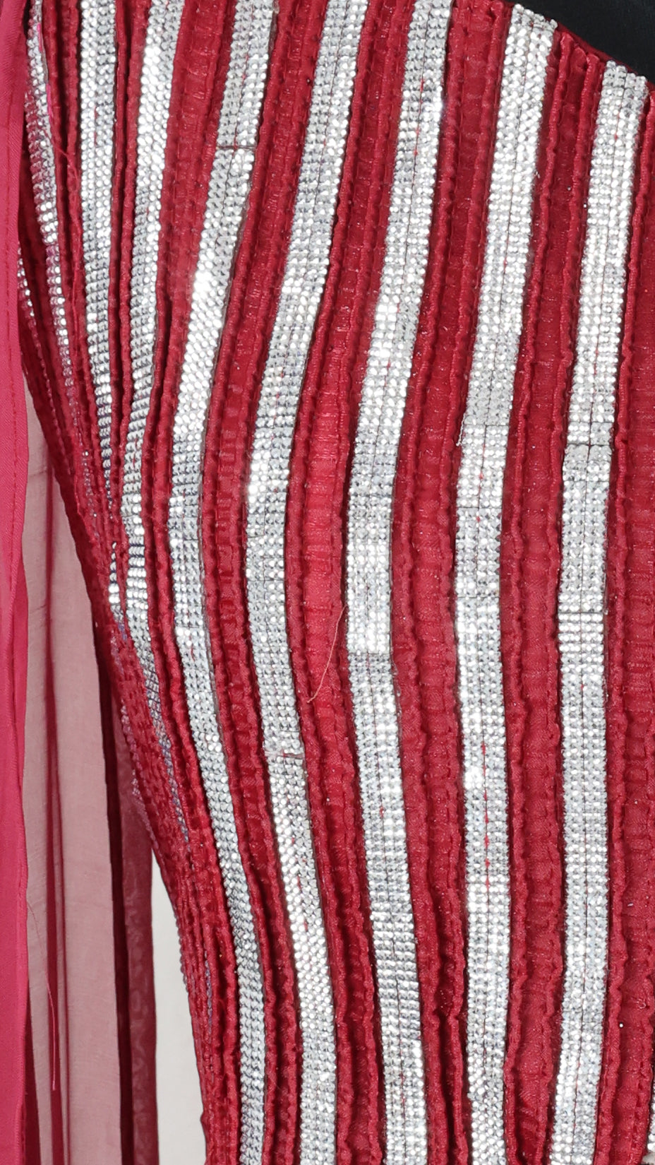 Close-up of red and silver striped fabric of maroon crop top