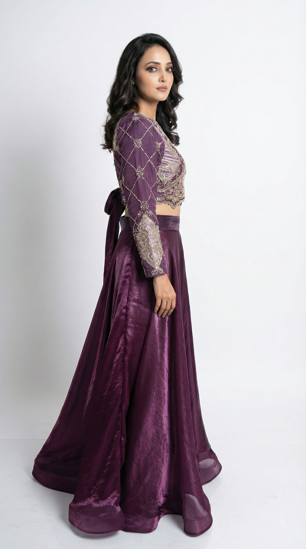 Woman wearing a purple traditional outfit with a white background