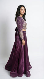 Woman wearing a purple traditional outfit with a white background