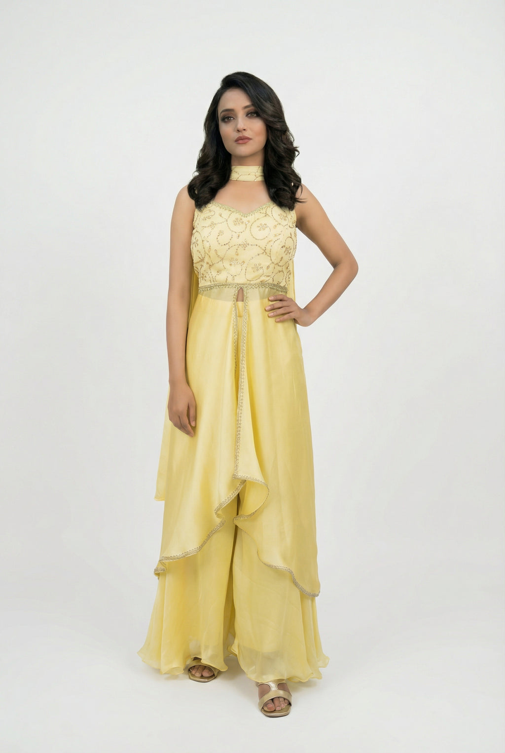 Close-up detail of the intricate golden kardana (glass bead) handwork on the yellow crop top blouse.