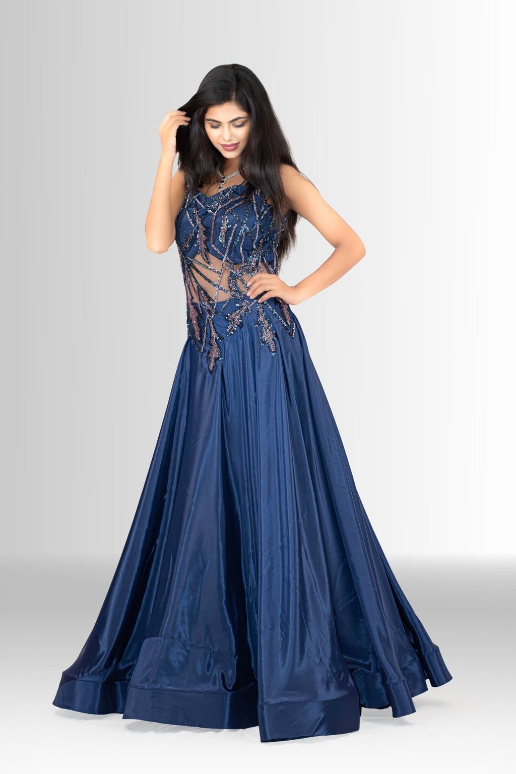 lose-up of the upper bodice of the navy blue gown, showing the detailed sequin and thread embroidery on the sheer net fabric, with a sparkling necklace.
