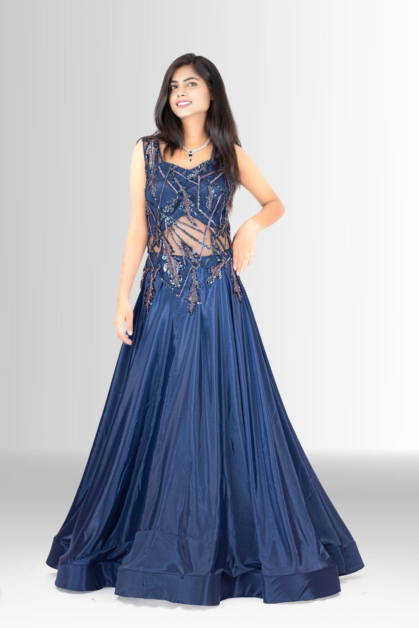 Woman posing confidently in the Rosio House navy blue sequin gown, emphasizing its elegant silhouette and the sparkling details.