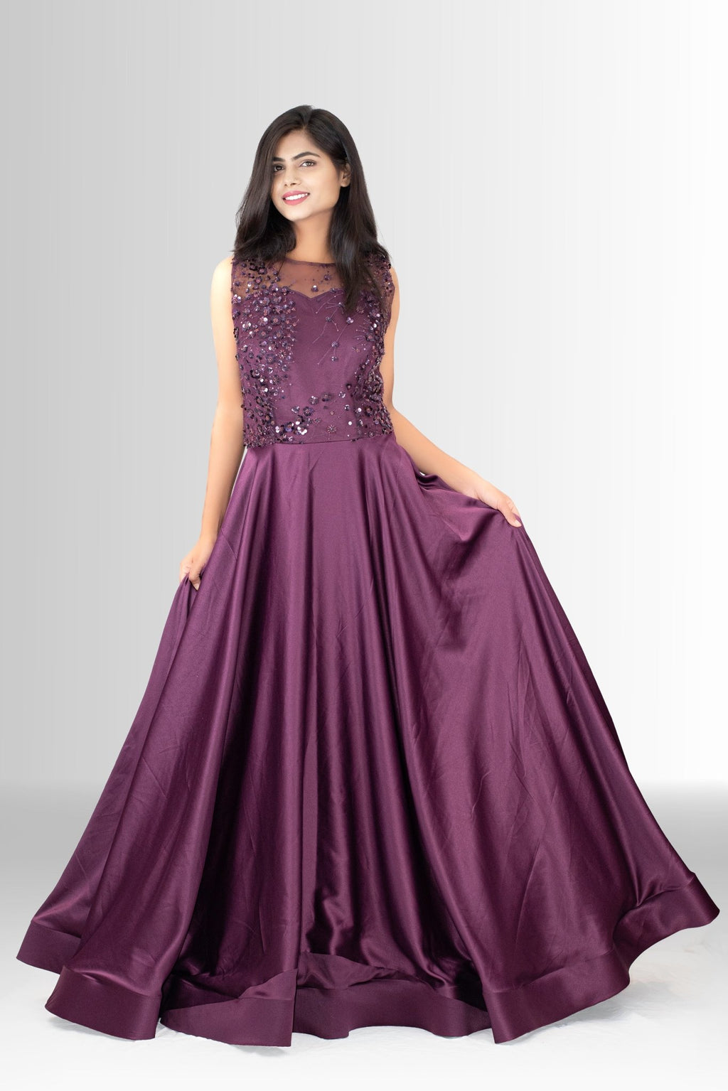 etail shot of the rich plum satin fabric used for the skirt of the formal gown, emphasizing its sheen and luxurious feel.