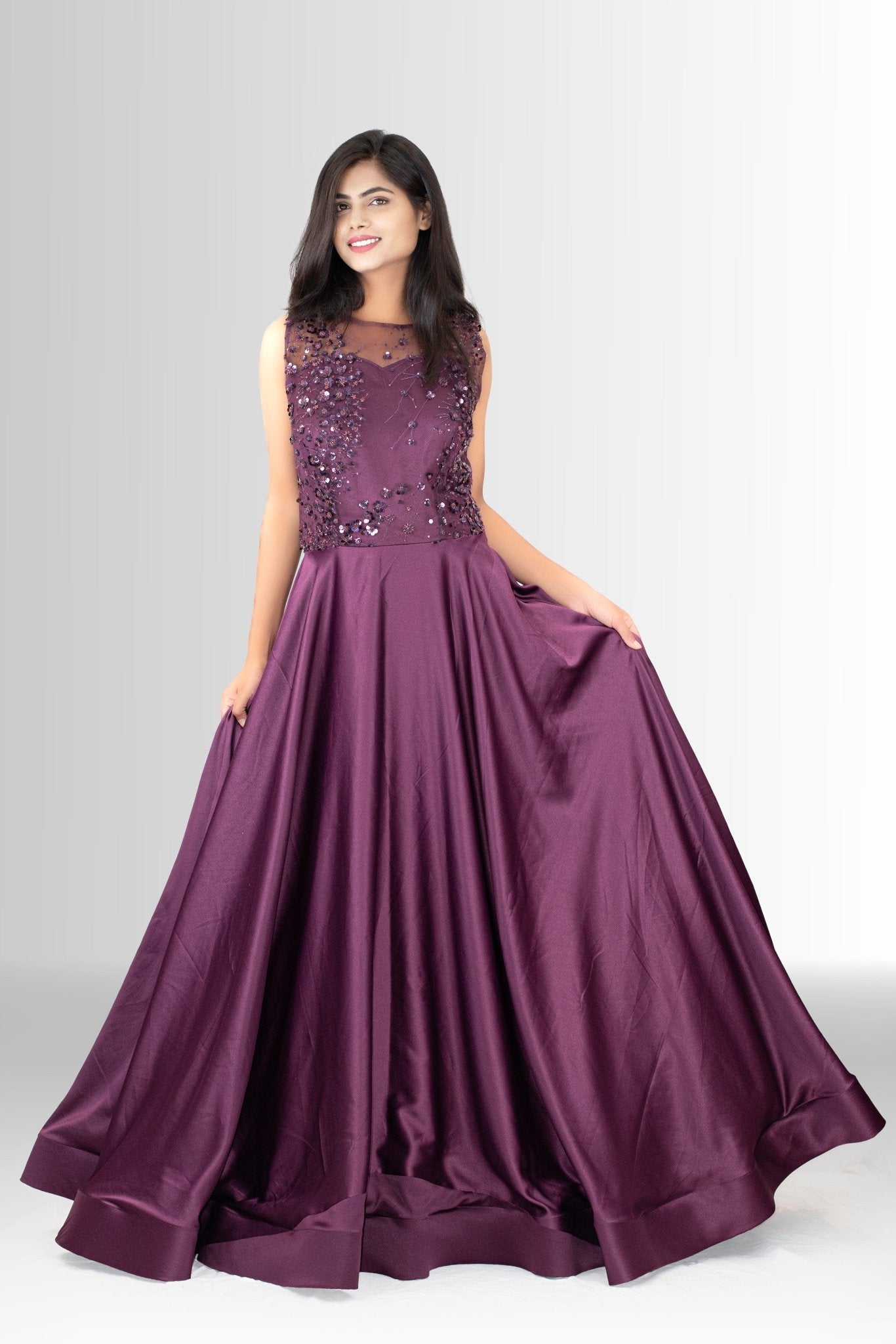 etail shot of the rich plum satin fabric used for the skirt of the formal gown, emphasizing its sheen and luxurious feel.