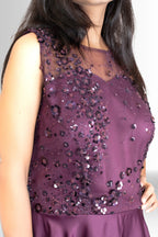 Back view of the elegant plum evening gown, showing its sleeveless design and the smooth, flowing satin fabric from the waist down.
