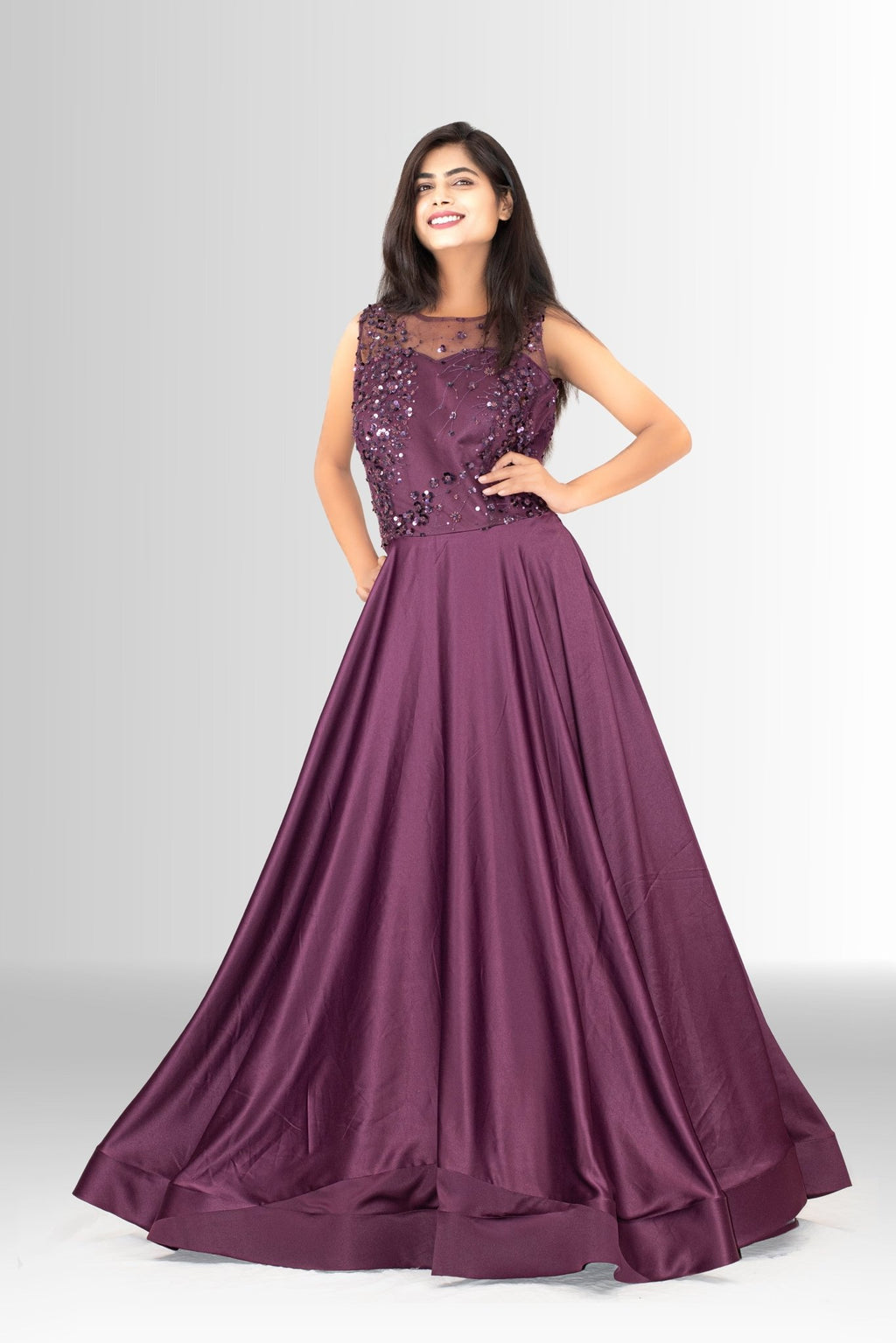 Side view of the plum A-line gown, highlighting the flattering silhouette and the lustrous drape of the floor-length satin skirt.