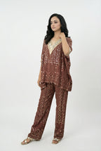 Side profile of the festive ethnic fusion set showing the relaxed, flowy drape of the kaftan top and comfortable fit of the pants.