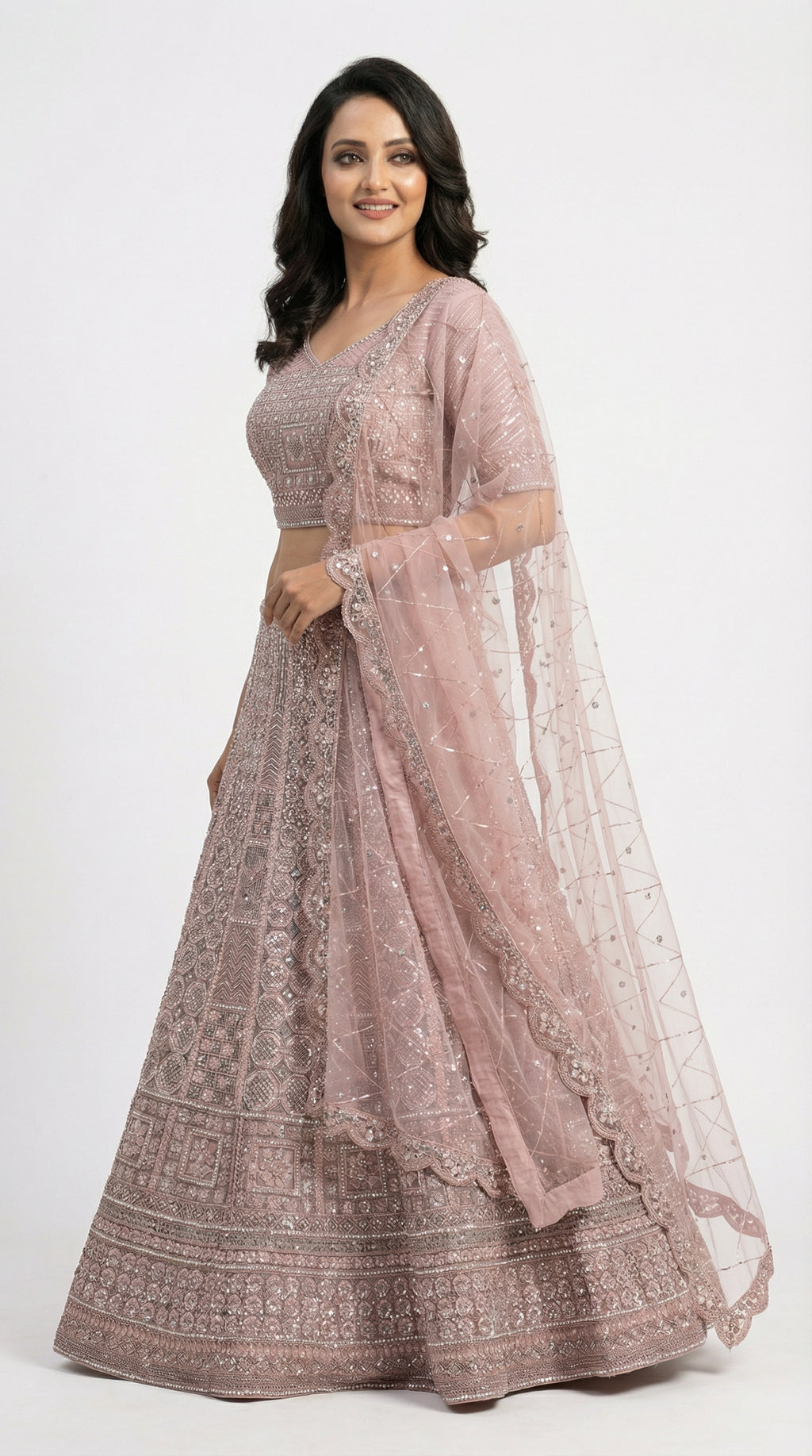 Close-up detail of the intricate geometric and floral silver handwork on the mauve lehenga skirt.