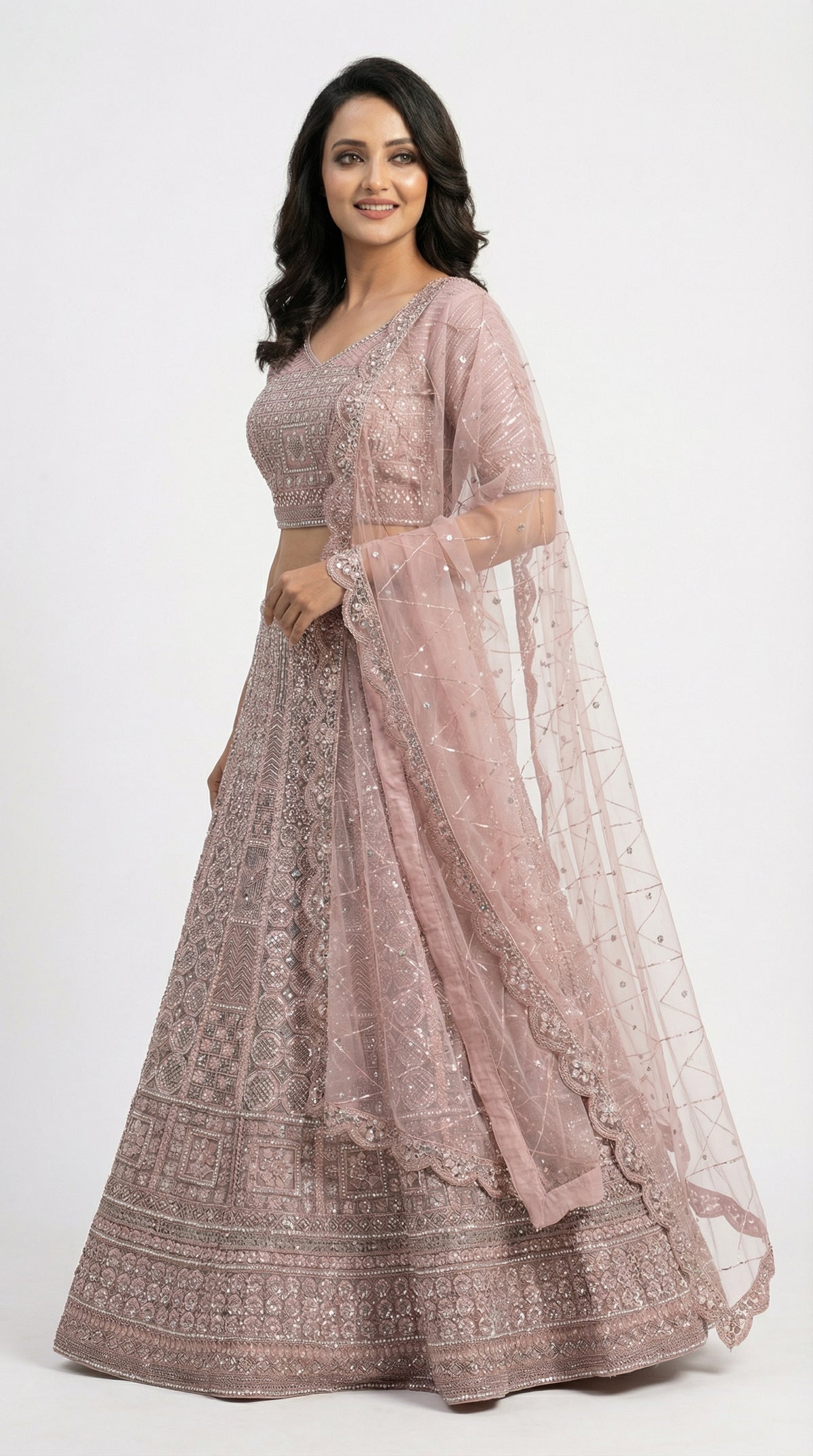 Close-up detail of the intricate geometric and floral silver handwork on the mauve lehenga skirt.