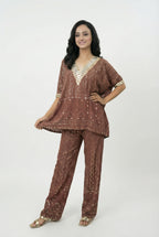 Close-up detail of the heavy silver mirror work (abhla bharat) embroidery on the V-neckline of the rust brown kaftan top.