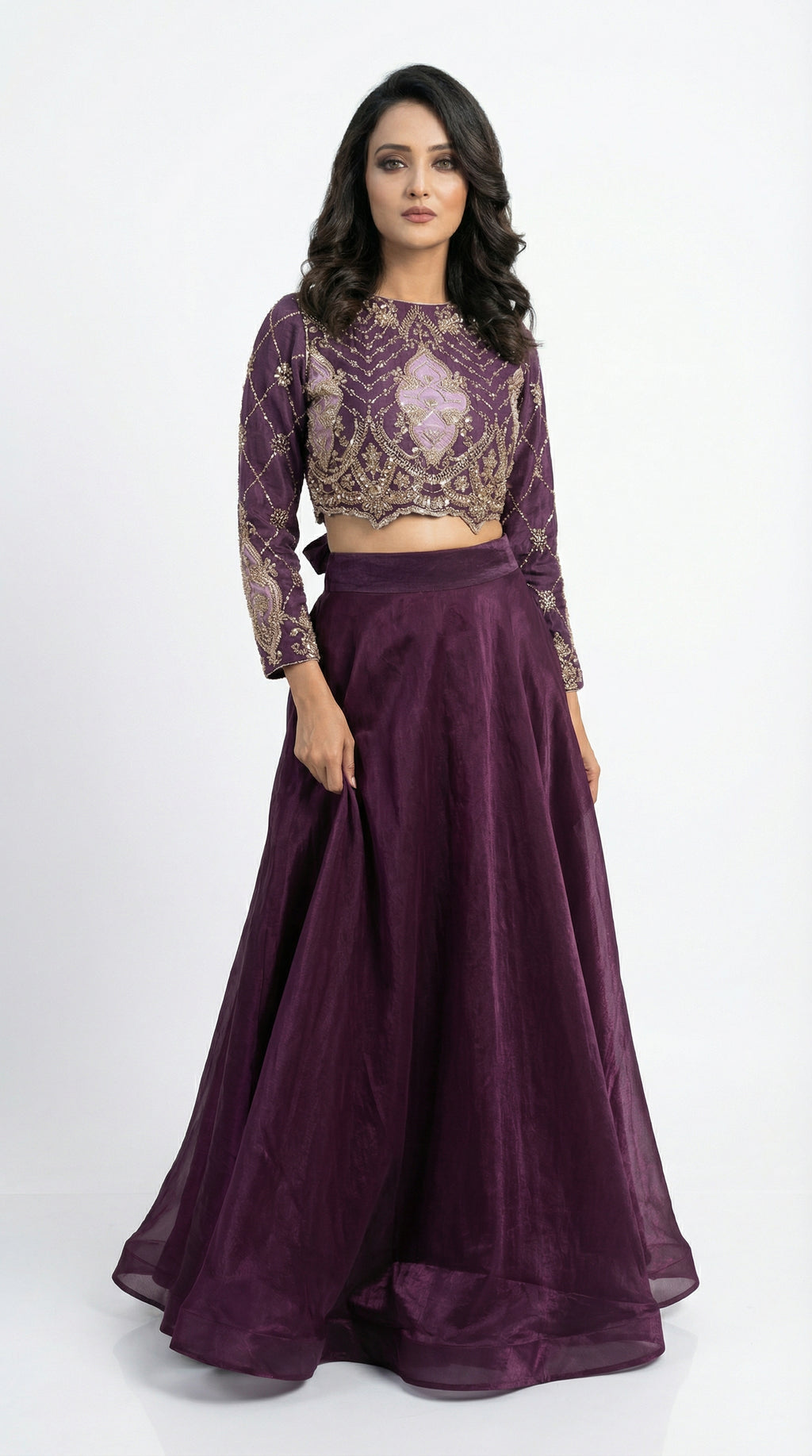 Side profile of the model wearing the purple handwork set, showing the transition from the heavy embroidered top to the flowy shimmer skirt.