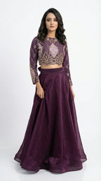 Side profile of the model wearing the purple handwork set, showing the transition from the heavy embroidered top to the flowy shimmer skirt.