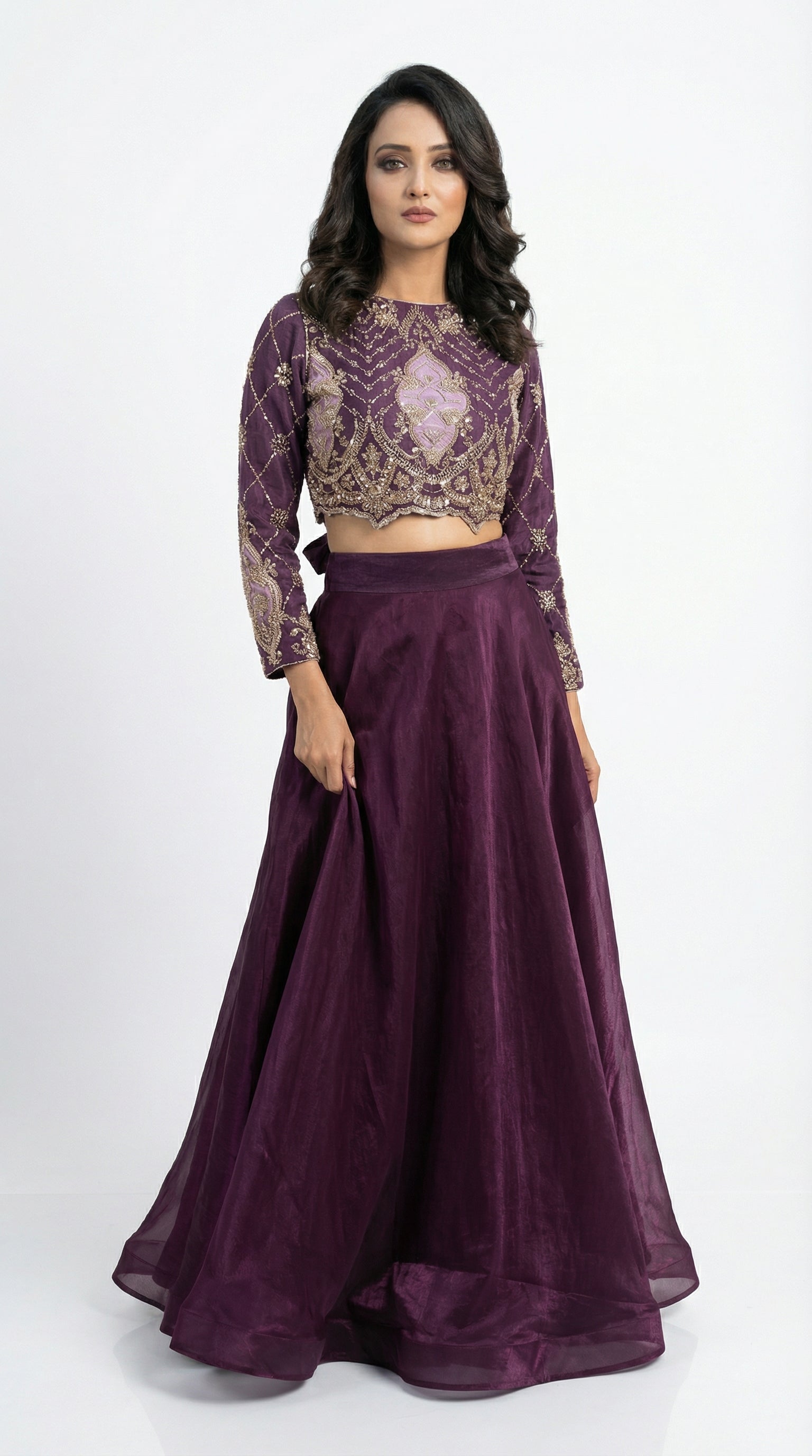 Side profile of the model wearing the purple handwork set, showing the transition from the heavy embroidered top to the flowy shimmer skirt.