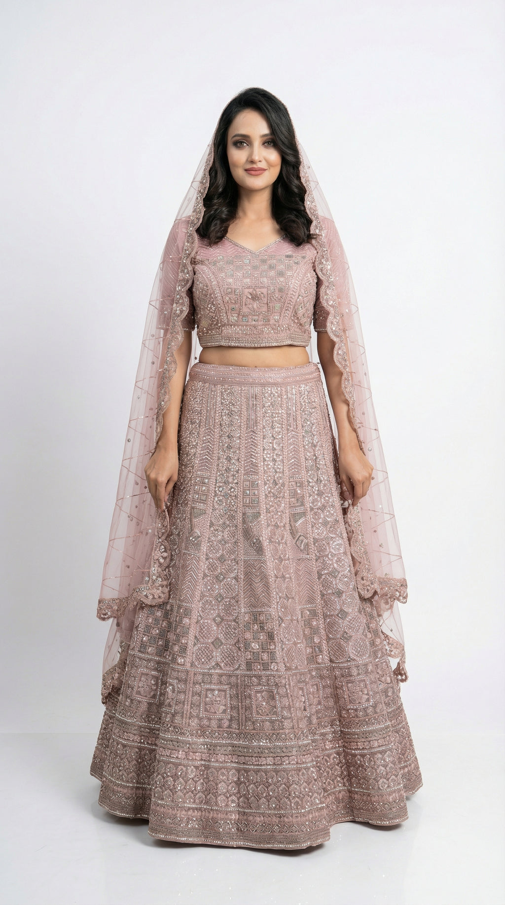 Close-up detail of the intricate geometric and floral silver handwork on the mauve lehenga skirt.