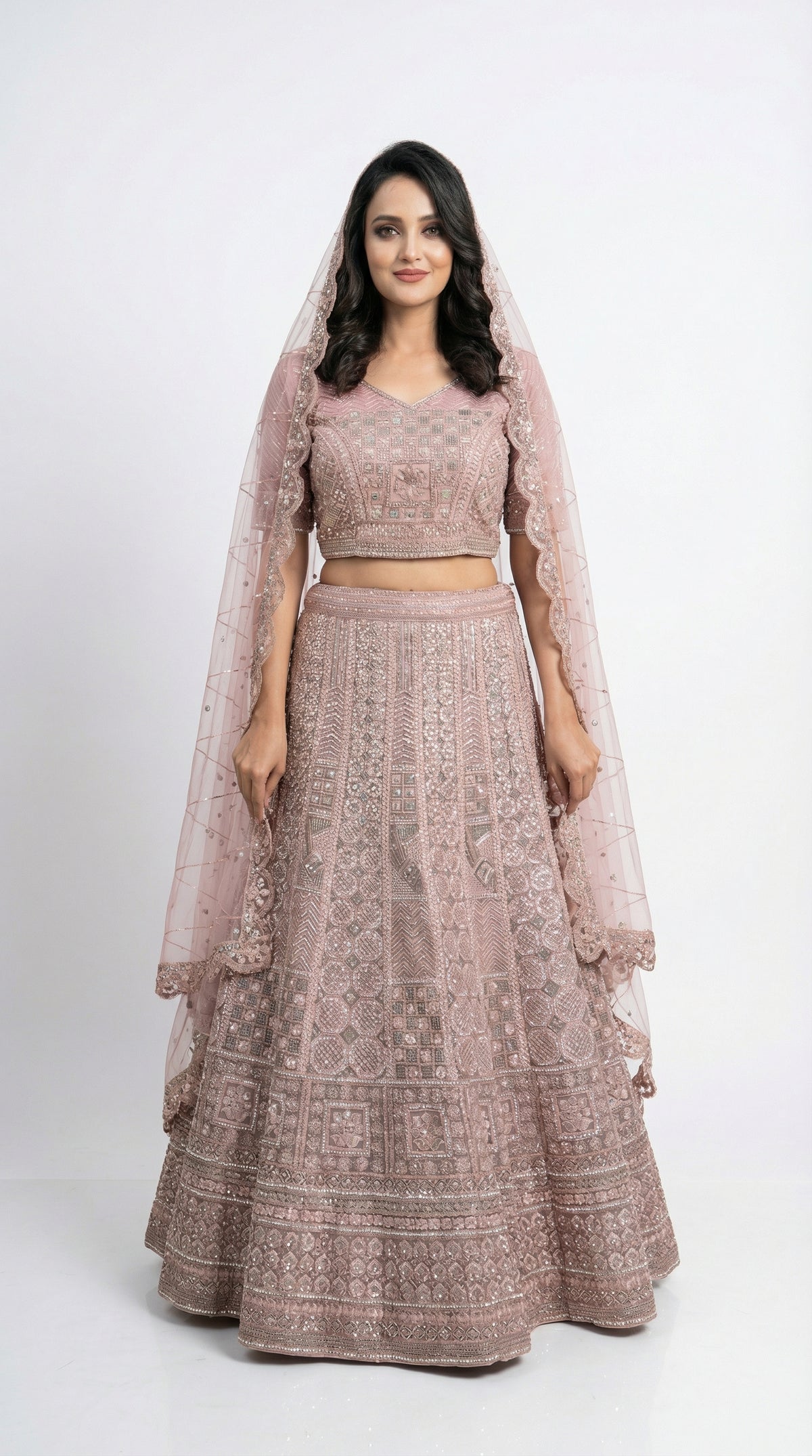 Close-up detail of the intricate geometric and floral silver handwork on the mauve lehenga skirt.