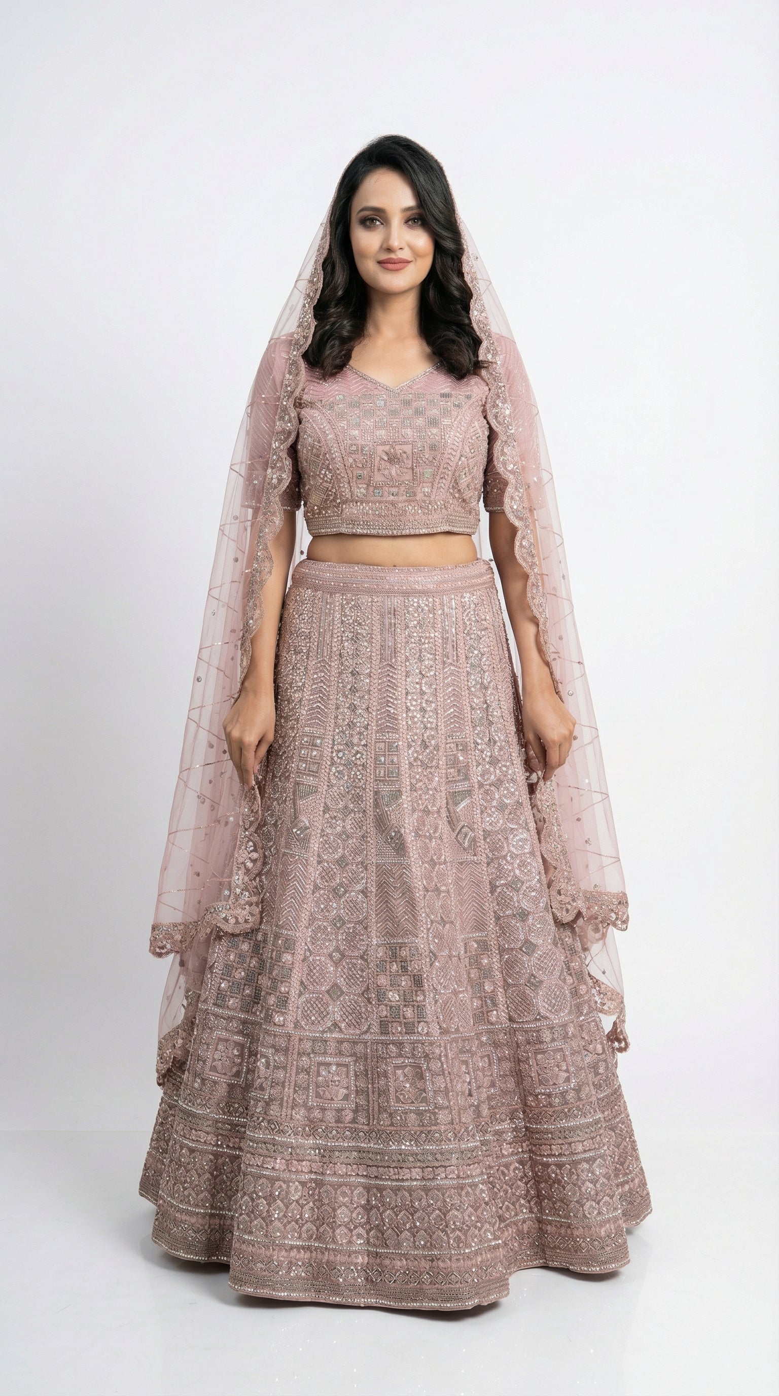 Close-up detail of the intricate geometric and floral silver handwork on the mauve lehenga skirt.