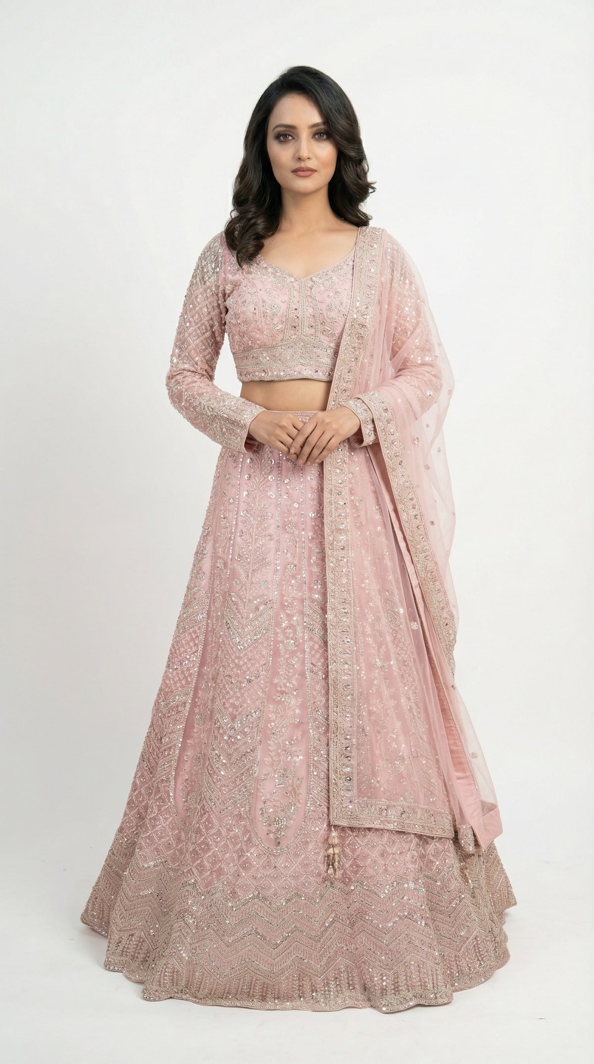 Woman wearing a pink traditional outfit with a white background