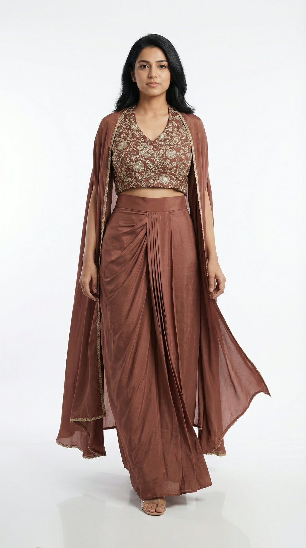 Woman wearing a brown indowestern outfit with a cape