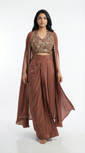 Woman wearing a brown indowestern outfit with a cape