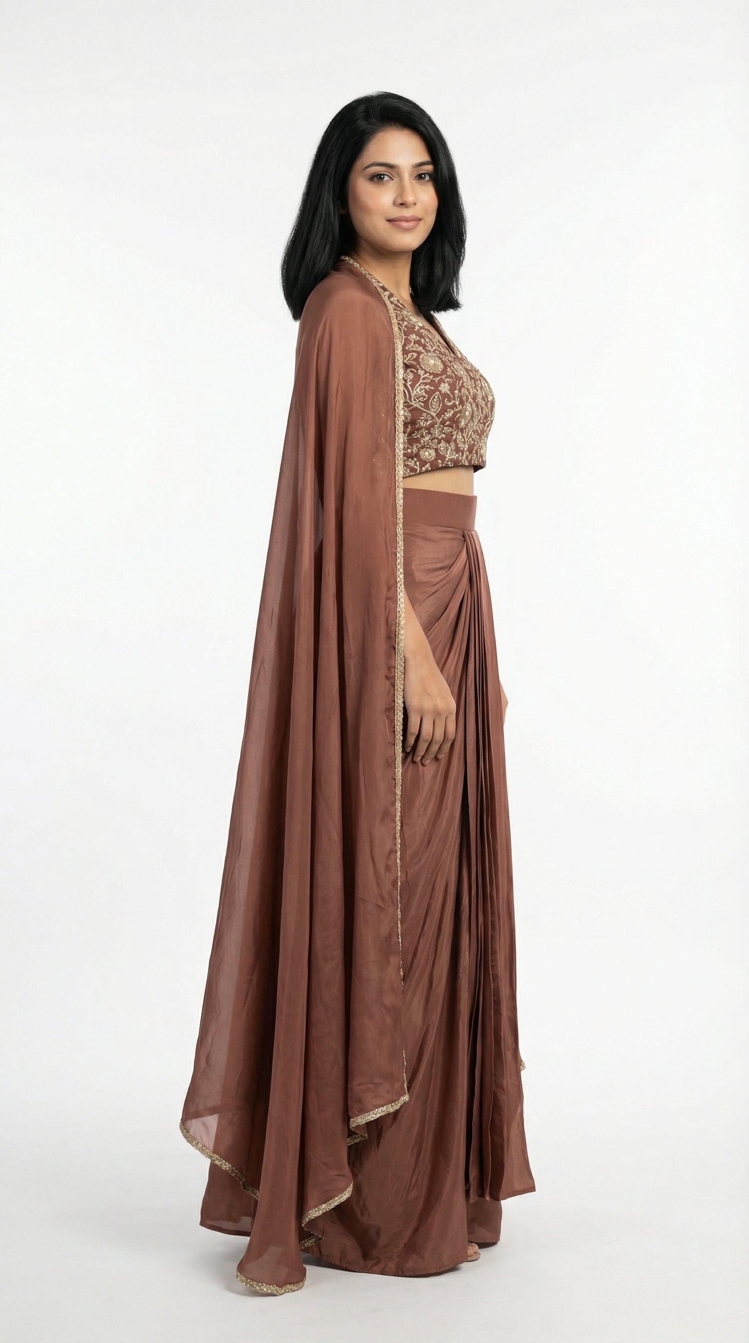 Woman wearing a brown indowestern outfit with a cape