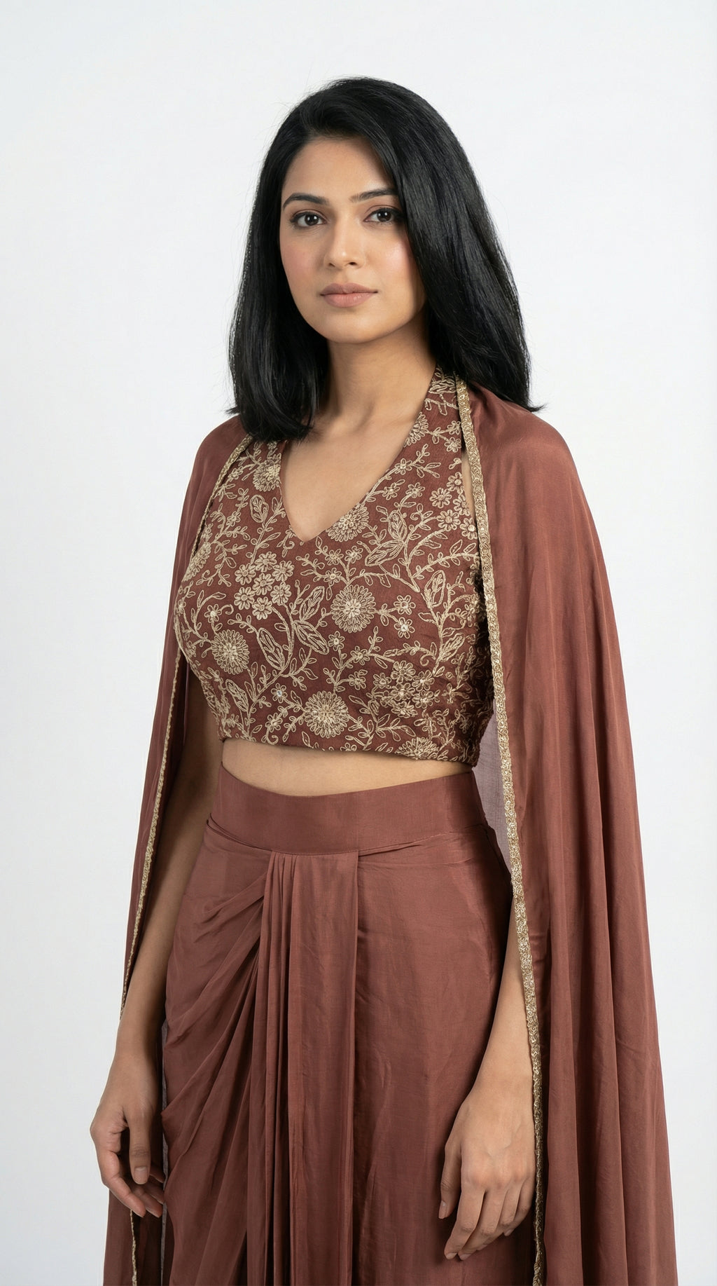 Woman wearing a brown indowestern outfit with a cape