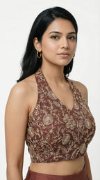 Woman wearing a brown indowestern outfit with a cape