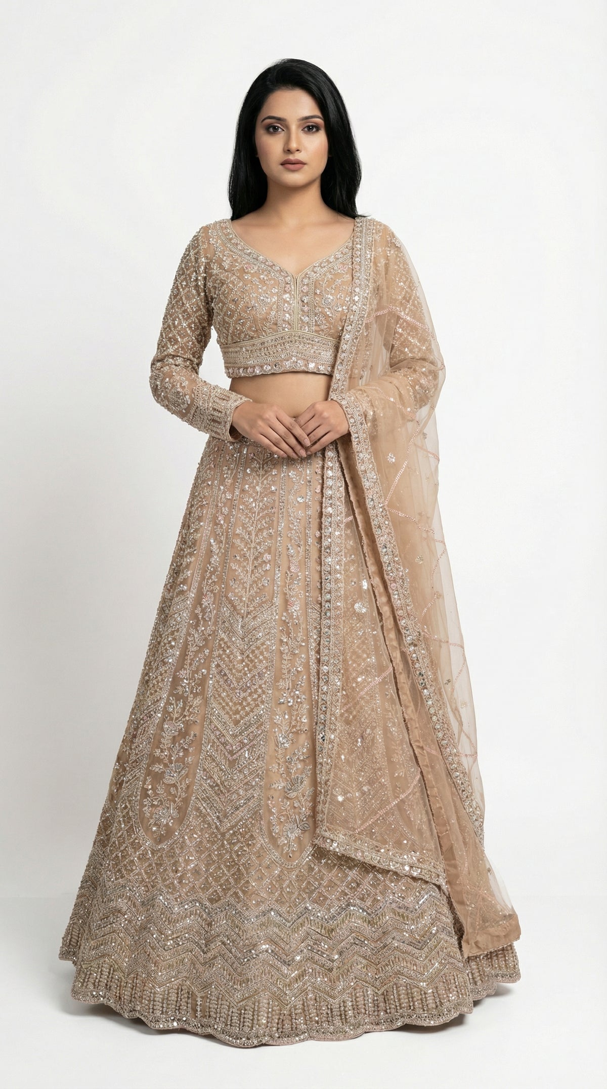 Woman wearing a beige embroidered lehenga for wedding, engagement and parties