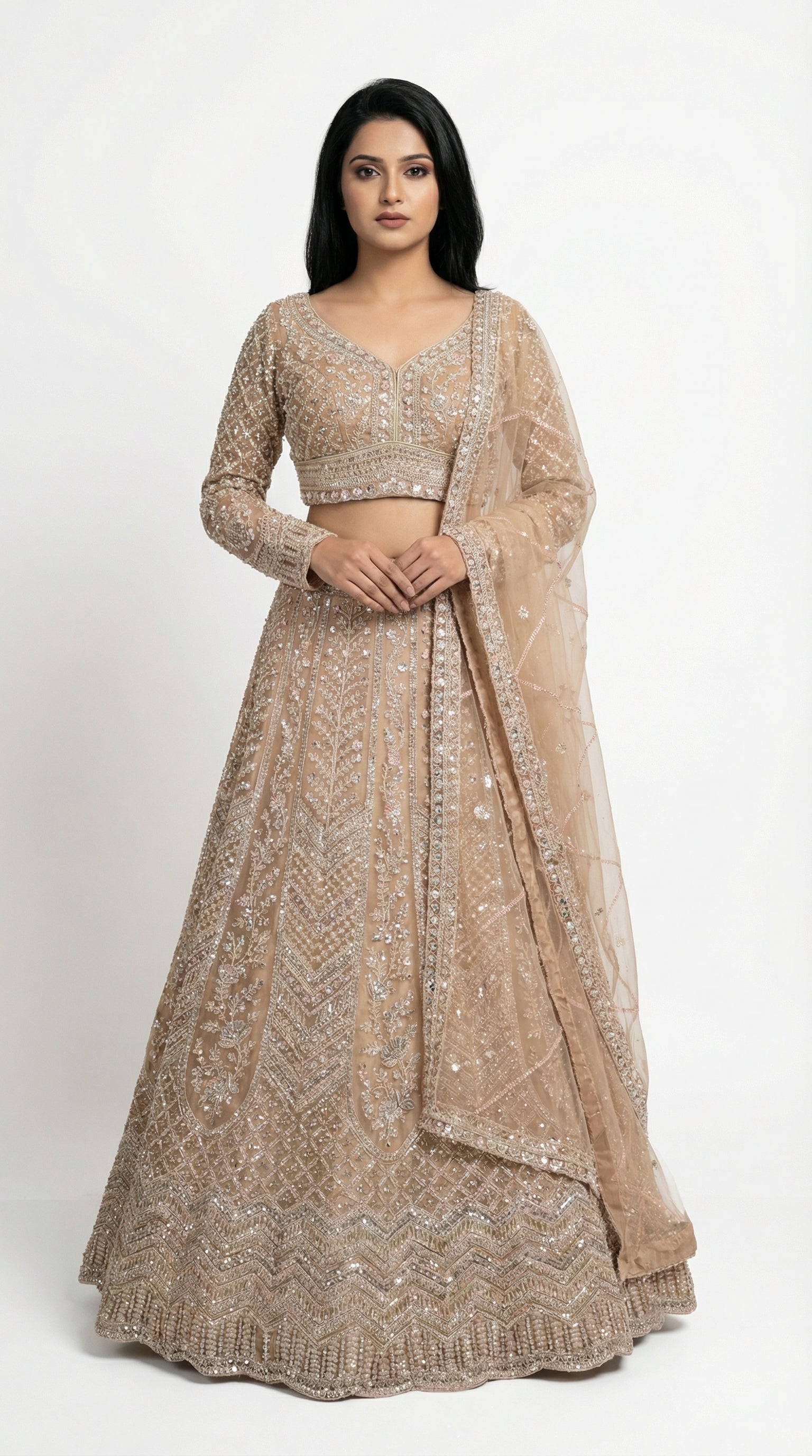 Woman wearing a beige embroidered lehenga for wedding, engagement and parties