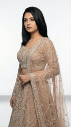 Woman wearing a beige embroidered lehenga for wedding, engagement and parties 3