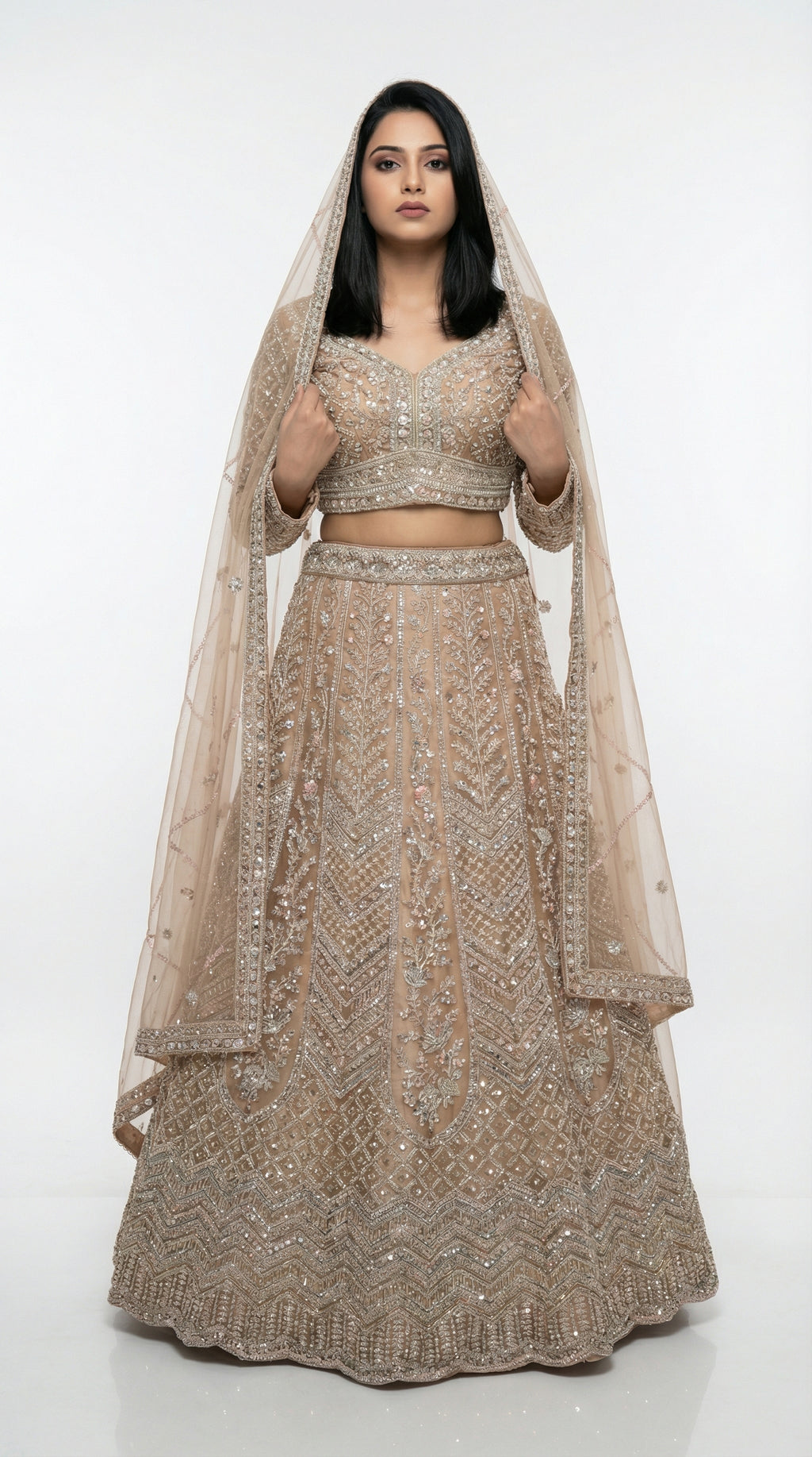Woman wearing a beaded lehenga with a matching dupatta on a white background