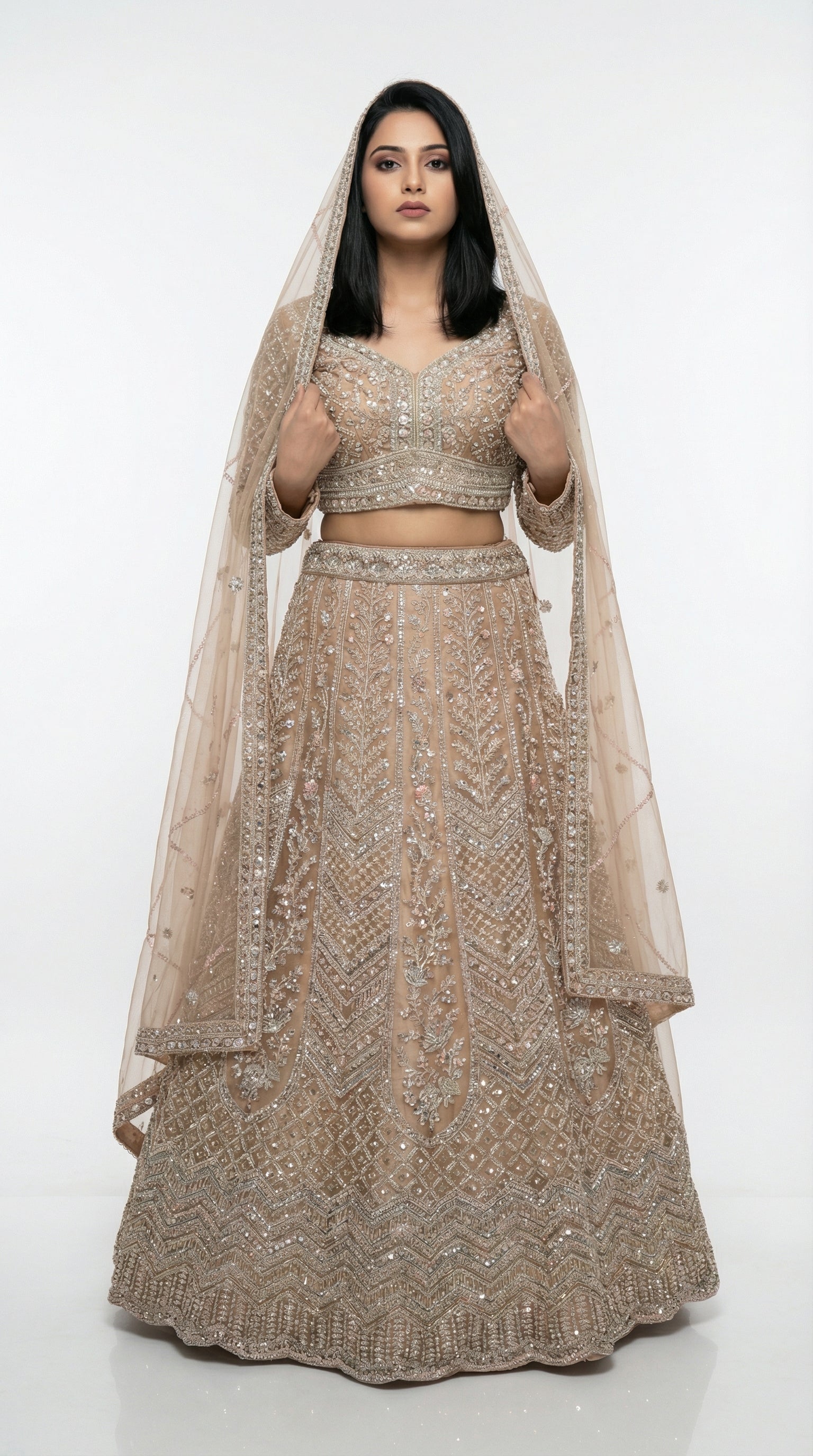 Woman wearing a beaded lehenga with a matching dupatta on a white background