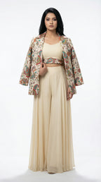 A view showing the solid off-white inner crop top layered under the printed blazer, highlighting the modern neckline.