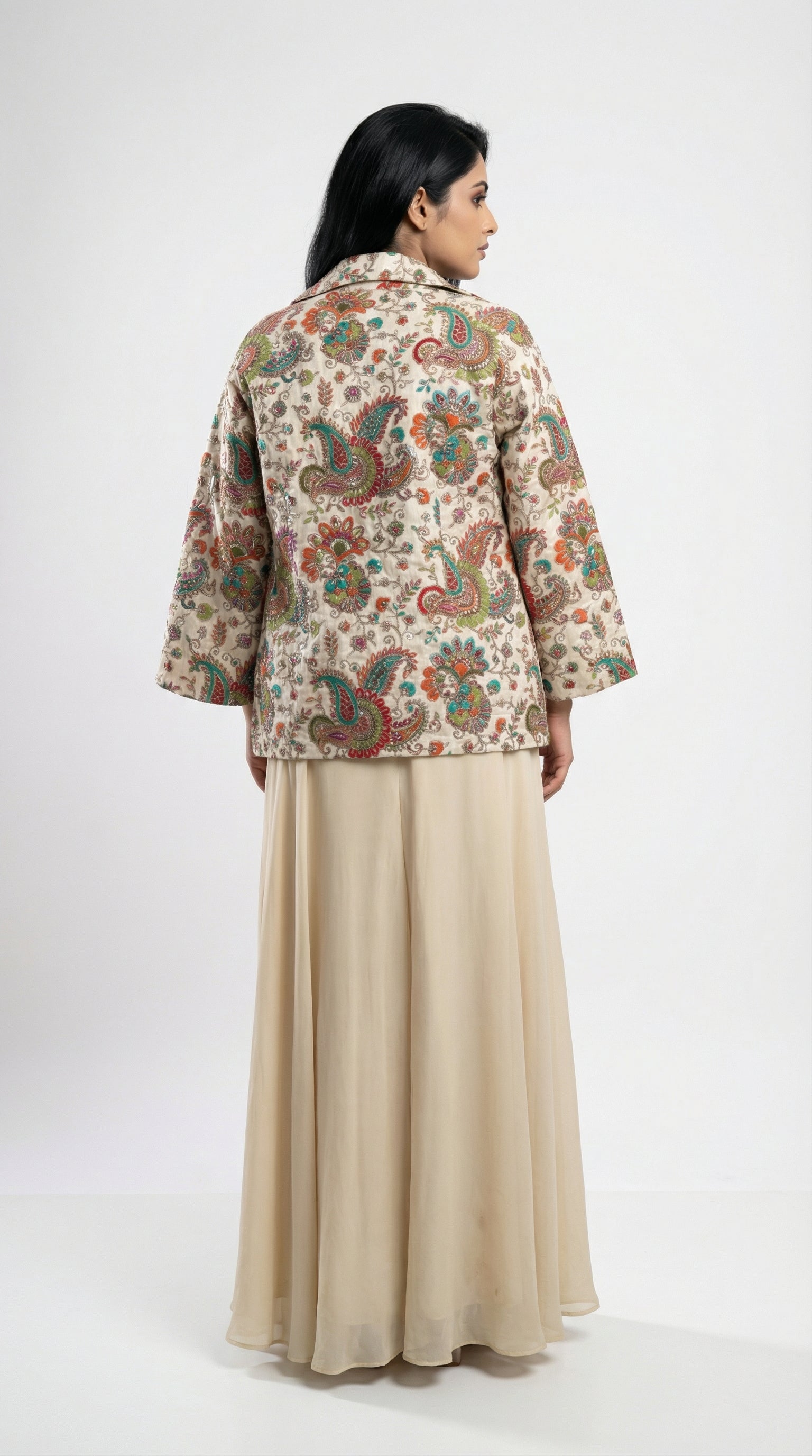 Detail shot of the solid off-white palazzo pants showing the flowy fabric texture and wide-leg silhouette.