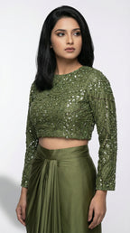 Woman wearing a green sequined top and skirt on a white background