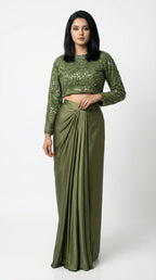 Woman wearing a green sequined top and skirt set on a white background