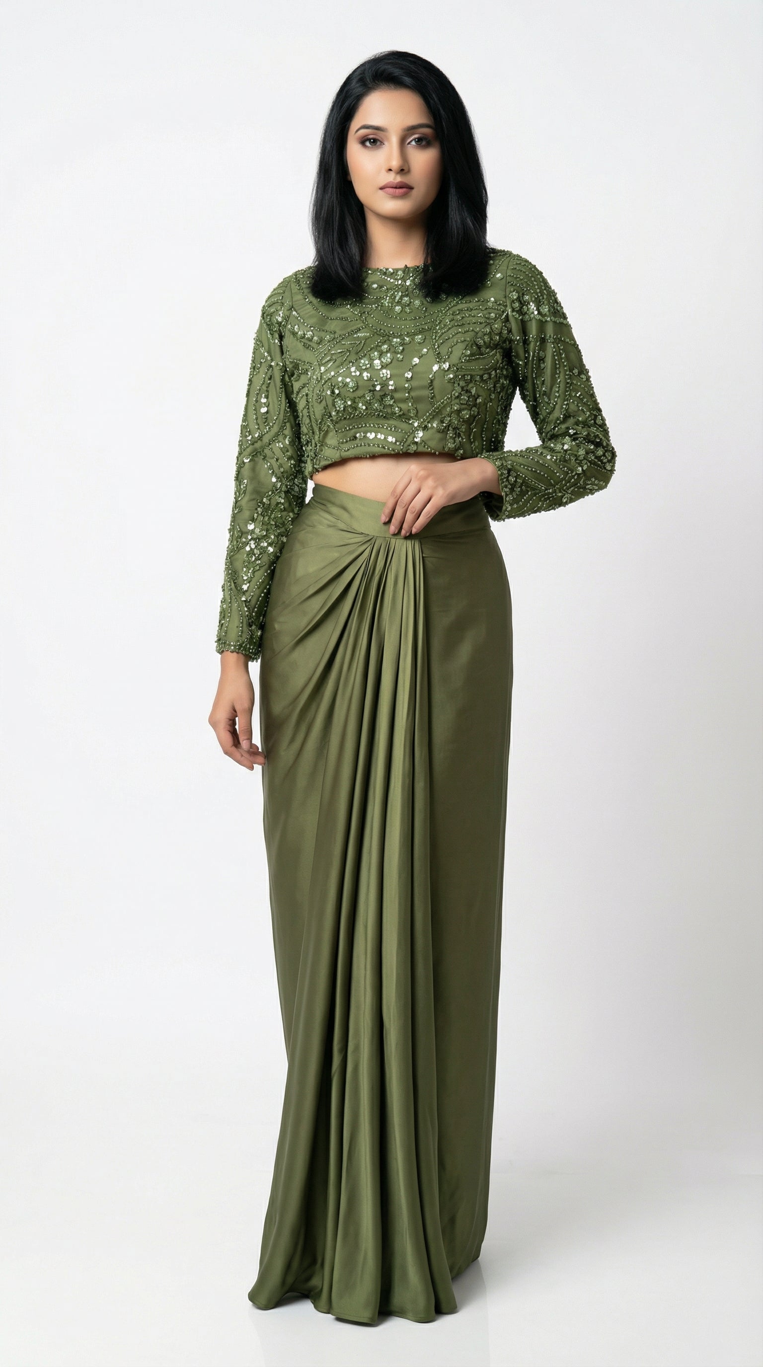 Woman wearing a green sequined top and skirt set on a white background