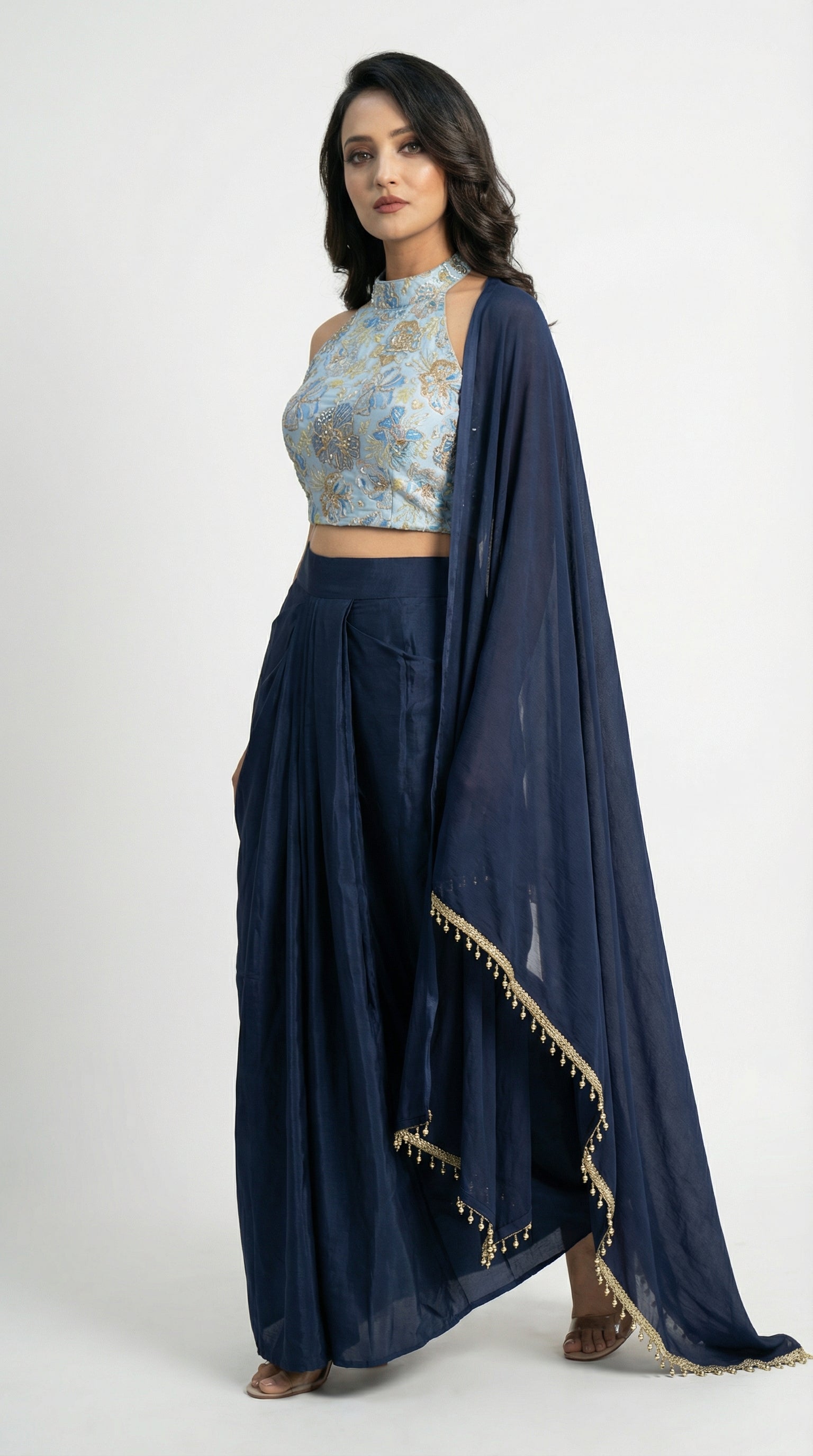 Detail shot showing the rich texture of the imported navy blue satin skirt and its elegant center-pleated drape.