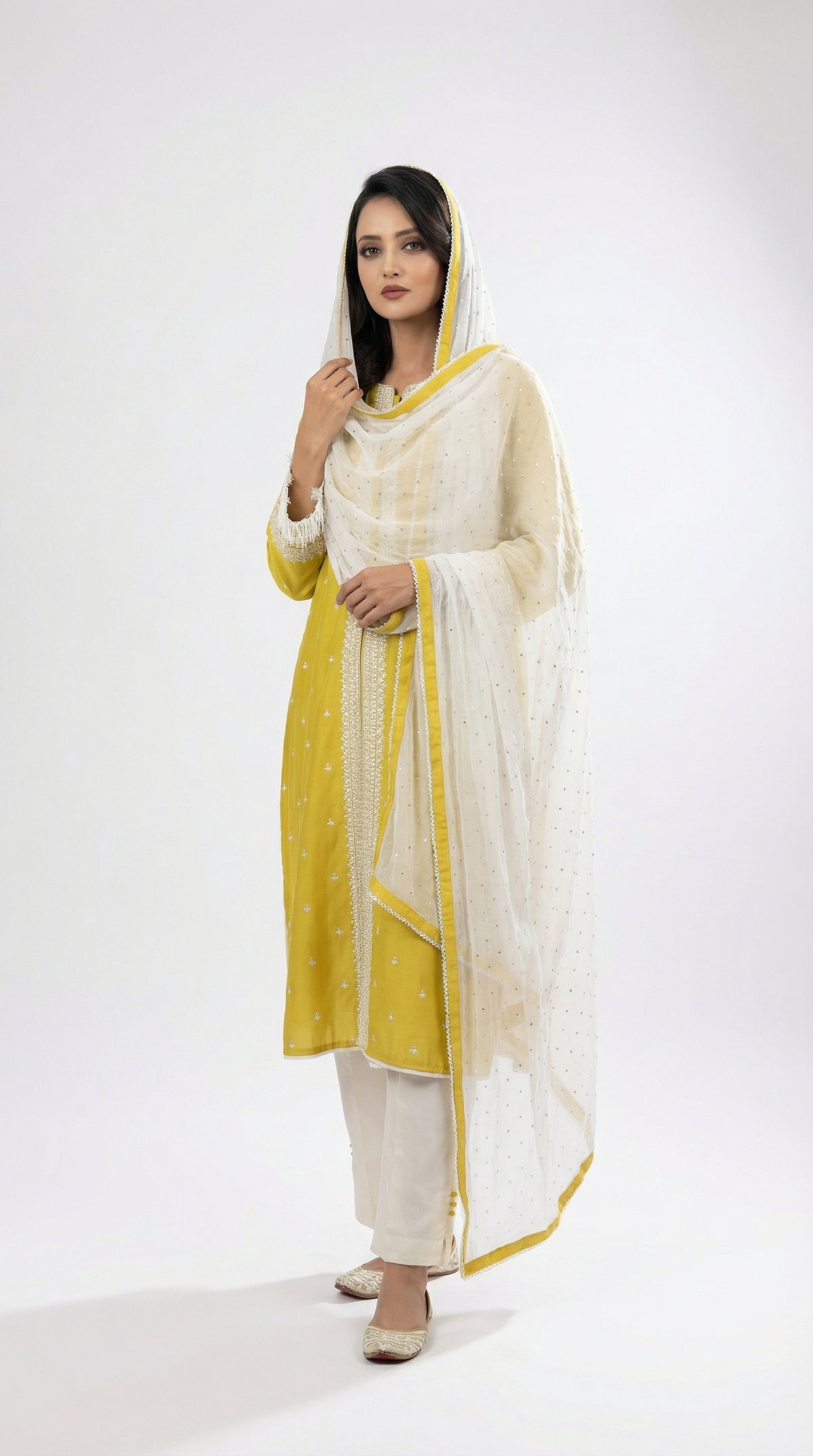 A sophisticated walking pose showing the elegant drape and fresh color palette of the lime green suit set.