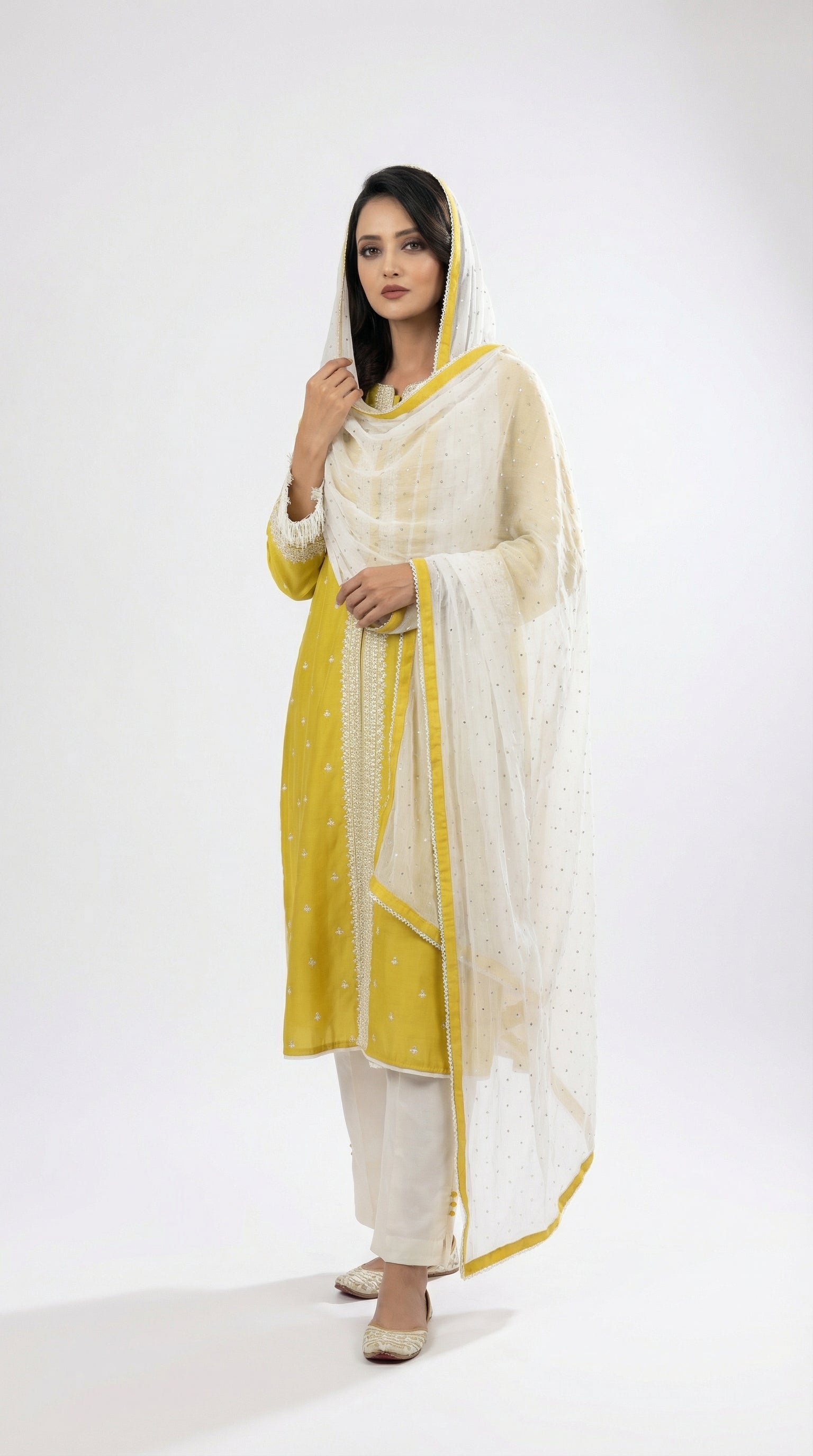 A sophisticated walking pose showing the elegant drape and fresh color palette of the lime green suit set.